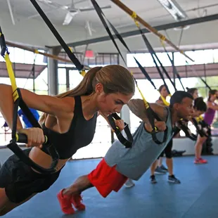 Our strength training area has windows, natural light, space, white details...