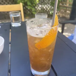 a glass of iced tea on a table