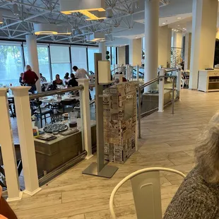 a dog sitting at a table in a restaurant