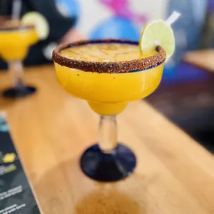 Mango margarita on the rocks with Tajin on the rim