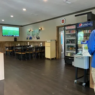 a man standing in front of a vending machine