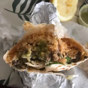 Supper burrito. Thick layer of rice followed by a thin layer of meat.