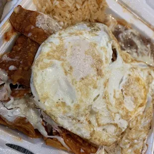 Chilaquiles red sauce , 2 eggs over medium ,rice and beans