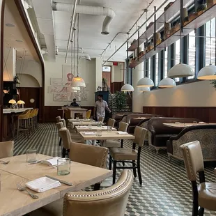 the interior of a restaurant with tables and chairs