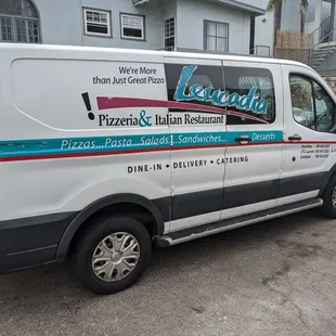 a van parked in front of a house