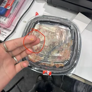 a piece of meat in a plastic container