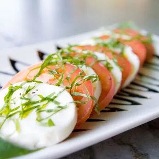 a plate of tomatoes and cheese