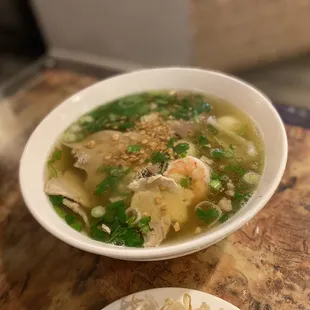 a bowl of soup and a plate of rice