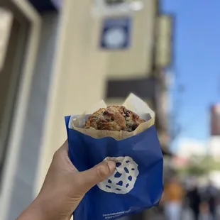a hand holding a bag of cookies