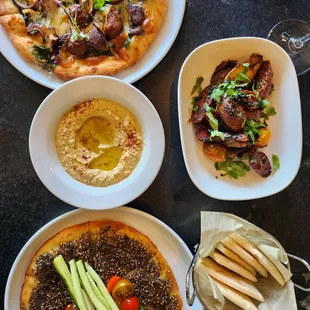 Gluten Free Mushroom &amp; Spinach man'ouch, Gluten Free Zaatar man'ouch, batata harra (spiced potato), and classic hummus with Gluten Free pita