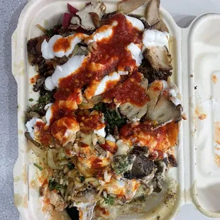 Rice, chicken and beef shawarma, pickled turnip, hummus, baba ghanouj, garlic sauce and hot sauce