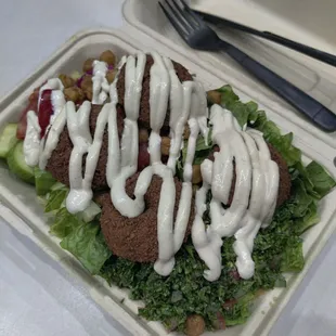 Rice pilaf with vermicelli underneath, Middle Eastern toppings and freshly made falafel on top