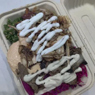 Rice pilaf underneath, Middle Eastern selection of toppings with spicy hummus and beef shawarma