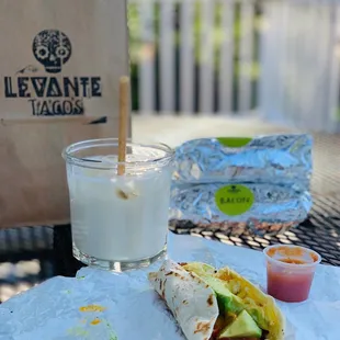 a burrito and a glass of milk