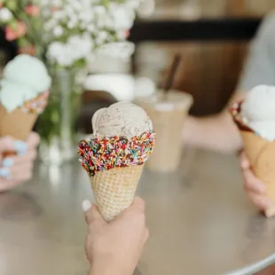 three people eating ice cream cones