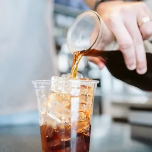 a person pouring a drink