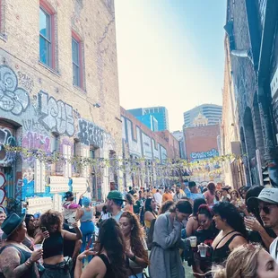 a crowd of people standing in front of a building