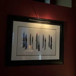 a framed picture of knives