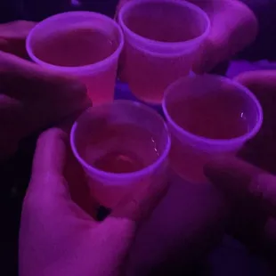 a group of people holding cups