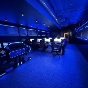 a gaming room with multiple computers