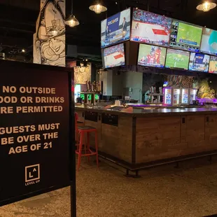 a bar with a sign that says no outside food or drinks are permitted guests must be over the age of 4