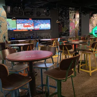 tables and chairs in a sports bar