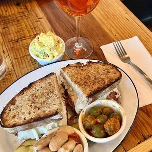 Pastrami Reuben Sandwich, Gigandes White Beans, Marinated Olives