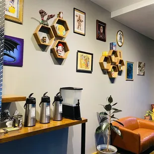 a living room with a couch, coffee maker, and shelves