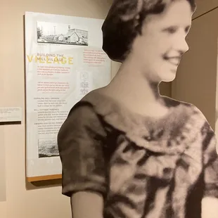 The sign behind the silhouette tells how a mill boss would knock on doors of employees if he saw their lights on too late!