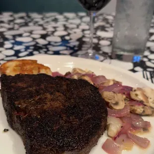 a steak and a glass of wine