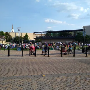 a crowd of people sitting and walking