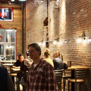 Erich Walls talks to a new customer in the taproom