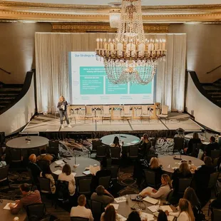 Custom Draping for Corporate Event with Accent Lighting and Screen from Levity Events