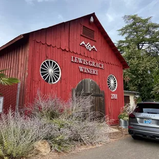 a car parked in front of a red building