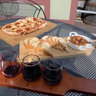 a table with two pizzas and two glasses of wine
