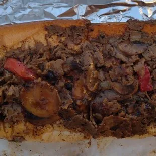 Cheesesteak sandwich with mushrooms, onions, red peppers, and wiz