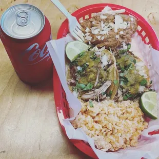 a plate of mexican food and a drink