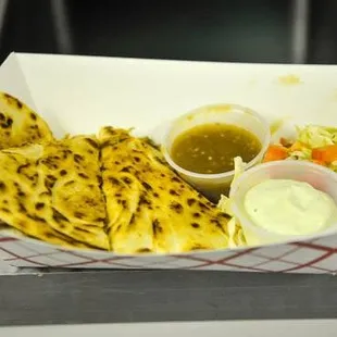 a plate of food and a bottle of ketchup