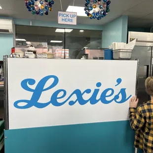 Pick Up Here - inside Lexi&apos;s. To the right is a freezer with pints &amp; to the left is the register