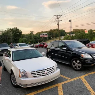 a man standing in a parking lot with cars