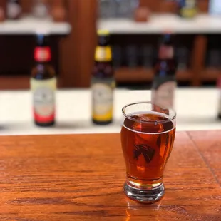 a glass of beer on a bar