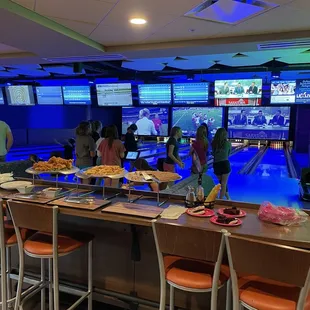 people playing a bowling game in a bowling alley