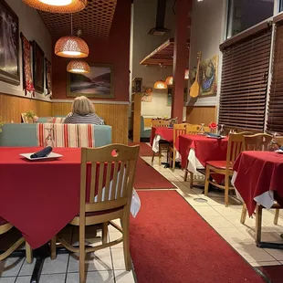 a woman sitting at a table in a restaurant