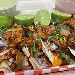 Pastor tacos with onions  and cilantro guacamole and red salsa