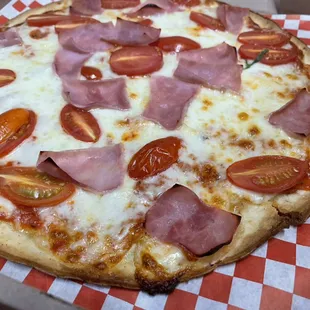 Cauliflower crust  ham pizza with cherry tomatoes