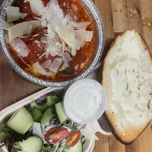 Dinner plate chicken parmigiana or meatballs parmigiana with bread with cheese and small salad