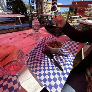 a woman eating at a picnic table