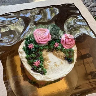a cake decorated with pink roses
