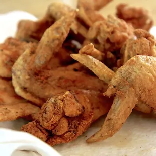 a pile of fried chicken on a napkin