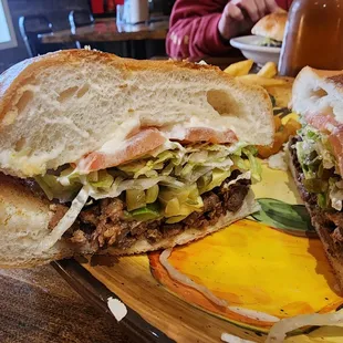 a sandwich and fries on a cutting board